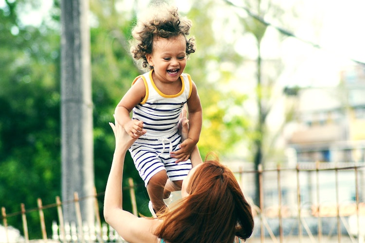 mom throwing kid
